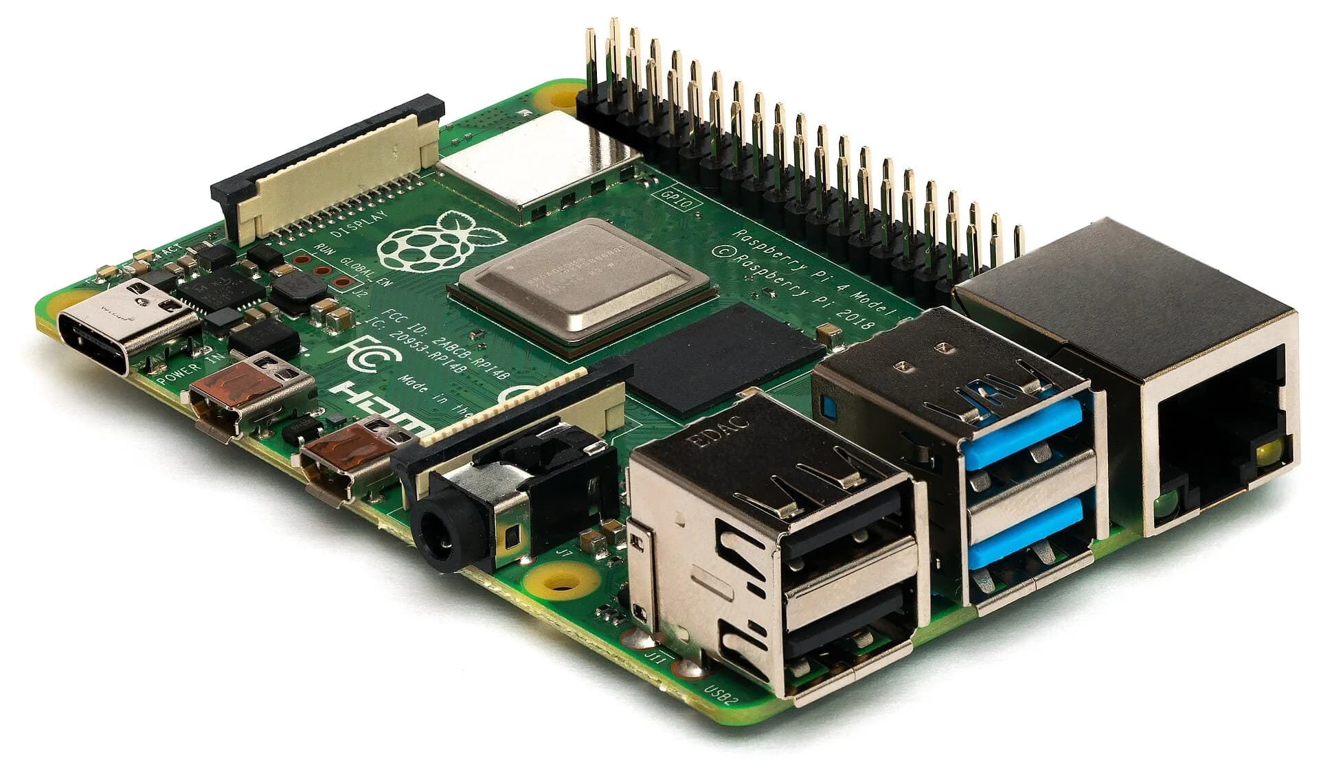 Photograph of a Raspberry Pi 4 Model B, a credit-card-sized green circuit board with a processor chip, memory, USB and Ethernet ports, two micro-HDMI ports and a row of GPIO pins along one edge.