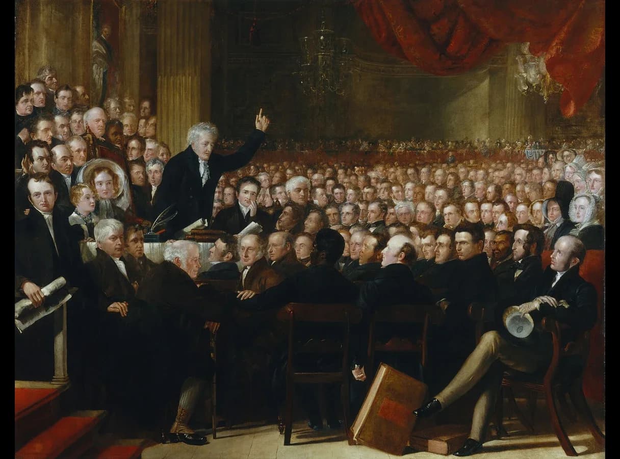 Large group painting of a crowded meeting hall. An elderly man speaks from the centre to rows of men in dark coats; a small number of women sit in the gallery and at the edges of the room.