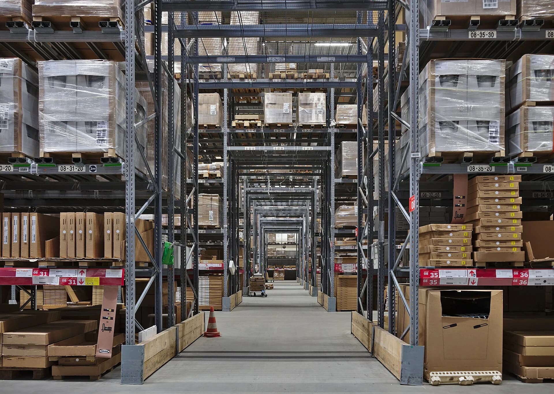 The self-serve warehouse of the IKEA store in Anderlecht, Belgium: long aisles of numbered racks holding flat-pack furniture in brown cardboard boxes, which customers collect themselves.