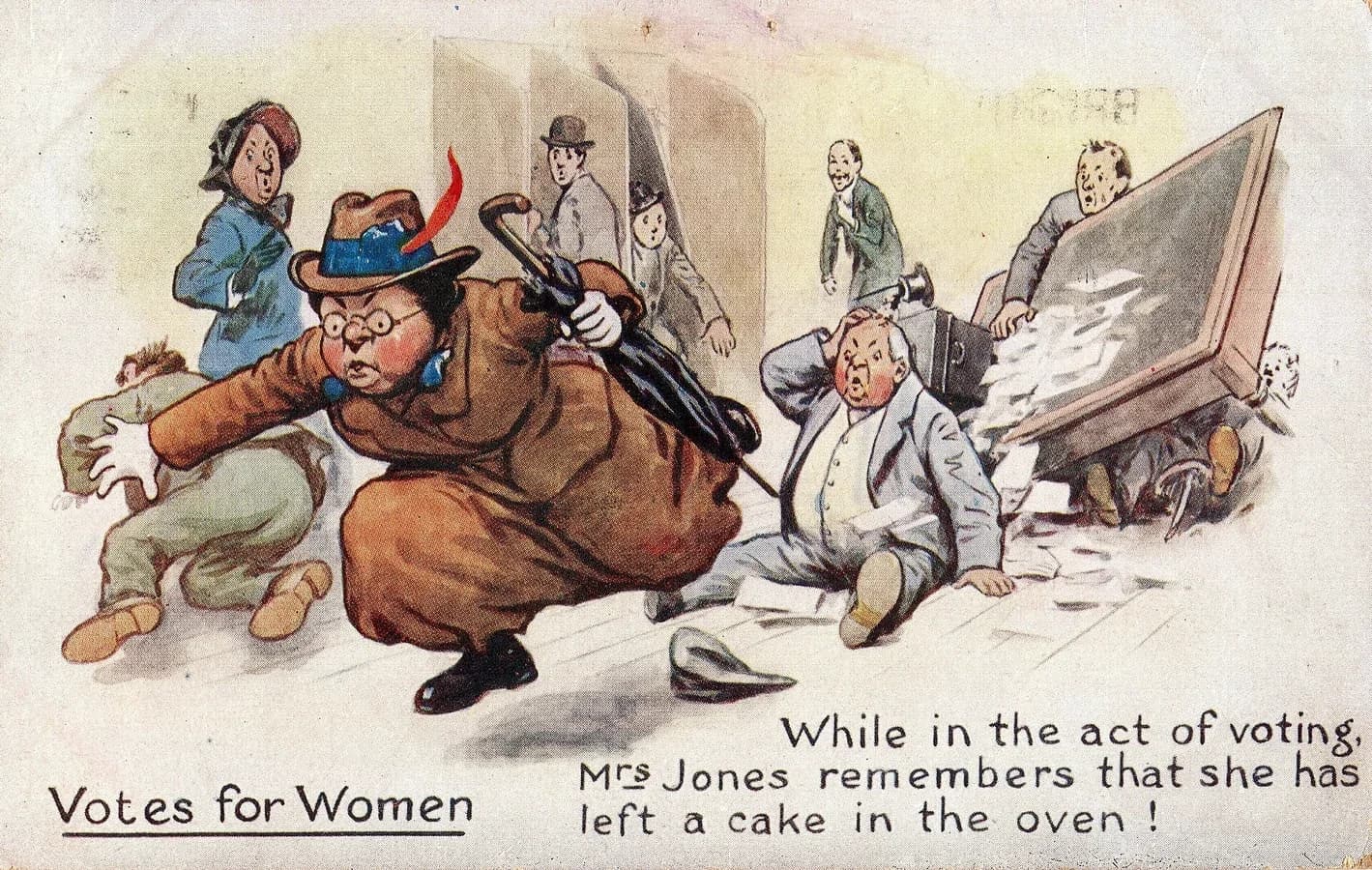 Coloured comic postcard headed Votes for Women. A stout woman in spectacles rushes out of a polling station, knocking men to the floor and overturning the ballot box. The caption reads: While in the act of voting, Mrs Jones remembers that she has left a cake in the oven!