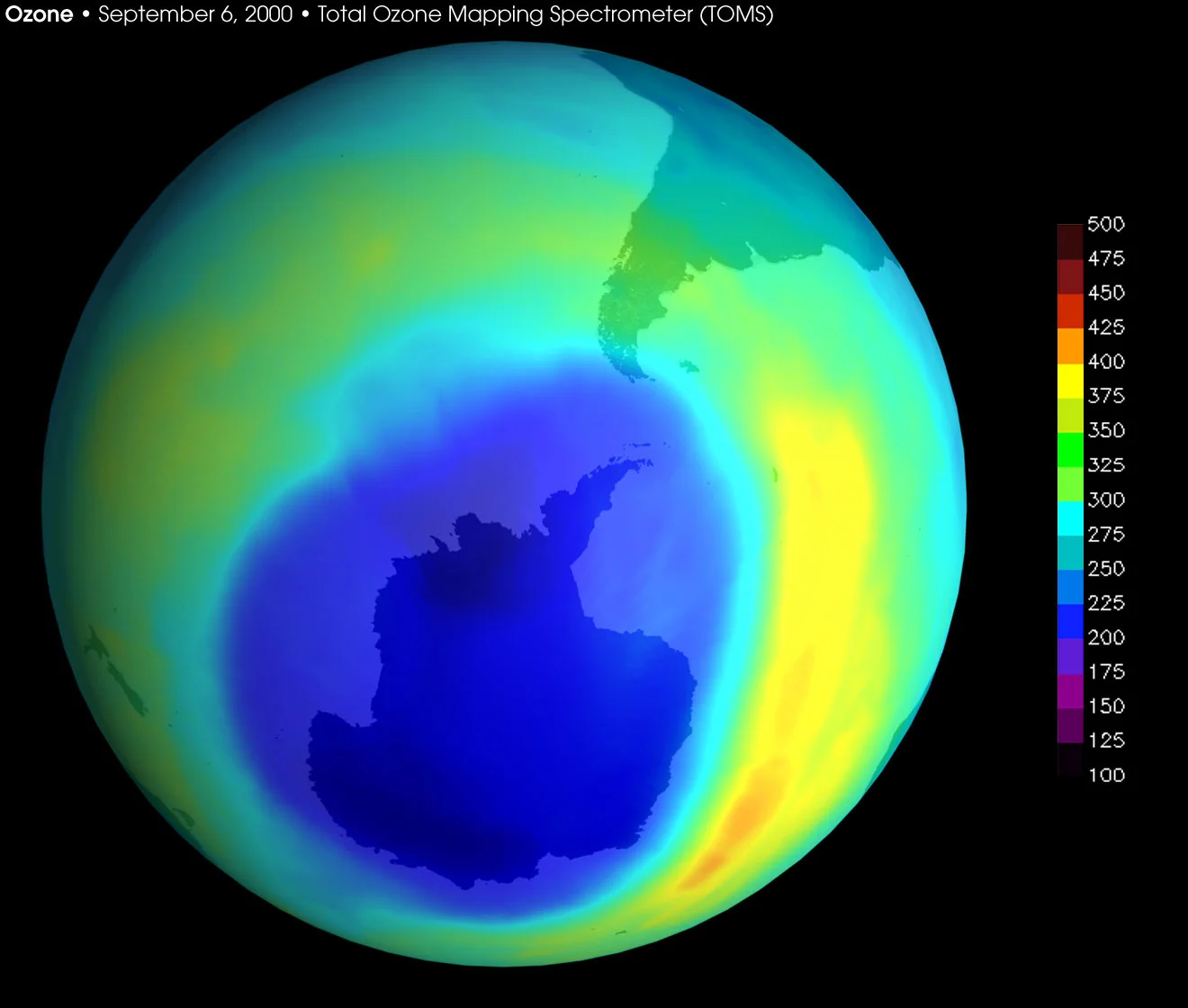 False-colour satellite map of total ozone over the Southern Hemisphere on 6 September 2000, with a scale in Dobson units: a large dark blue area below about 220 DU covers Antarctica and reaches towards the tip of South America.