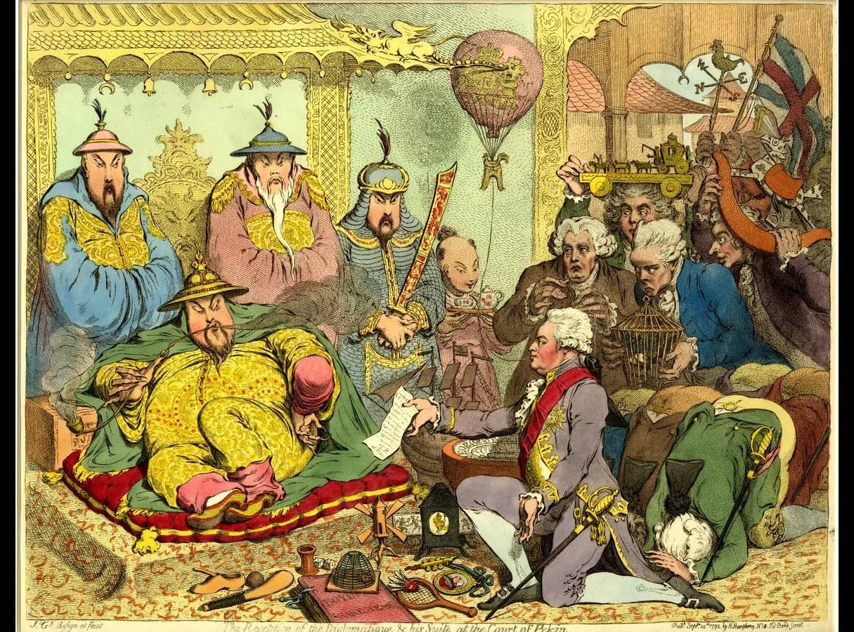 Hand-coloured etching. A Chinese emperor reclines on a dais smoking a long pipe while a British envoy kneels on one knee before him holding out a letter; behind the envoy, his suite offer toys, a balloon and small gifts. Chinese courtiers stand around the emperor.
