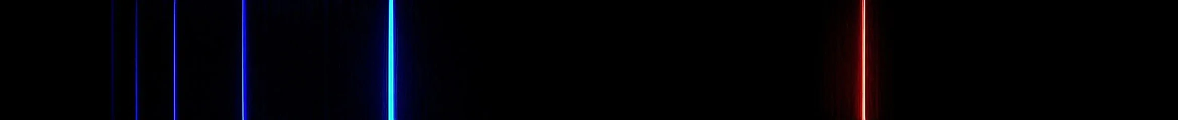 Photograph of the visible emission spectrum of hydrogen against a black background: a bright red line on the right, a blue-green line, and several fainter violet lines crowding together towards the left.