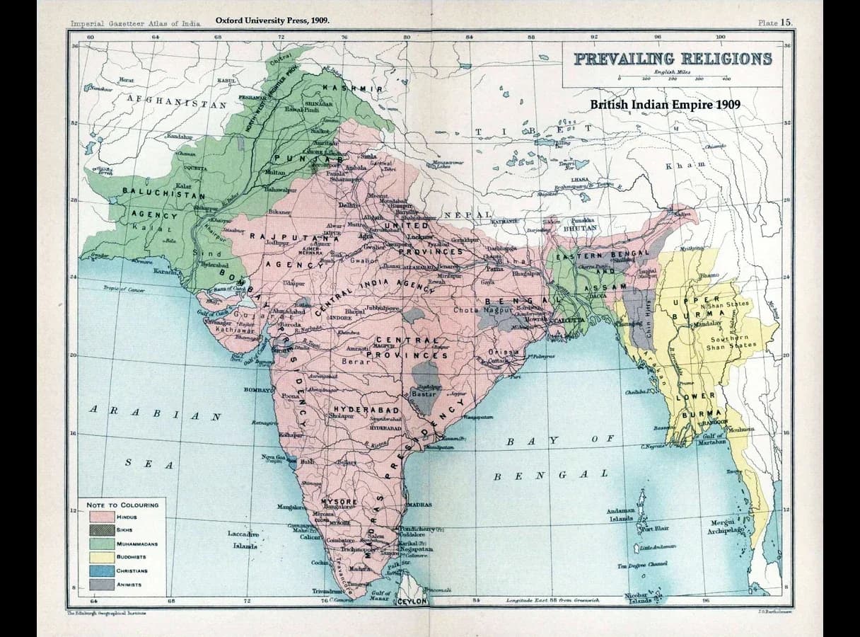 Map of the British Indian Empire in 1909 coloured by majority religion: Hindu-majority areas in pink across most of the subcontinent, Muslim-majority areas in green in the north-west and in eastern Bengal, a small Sikh area in Punjab, Buddhist Burma in yellow.