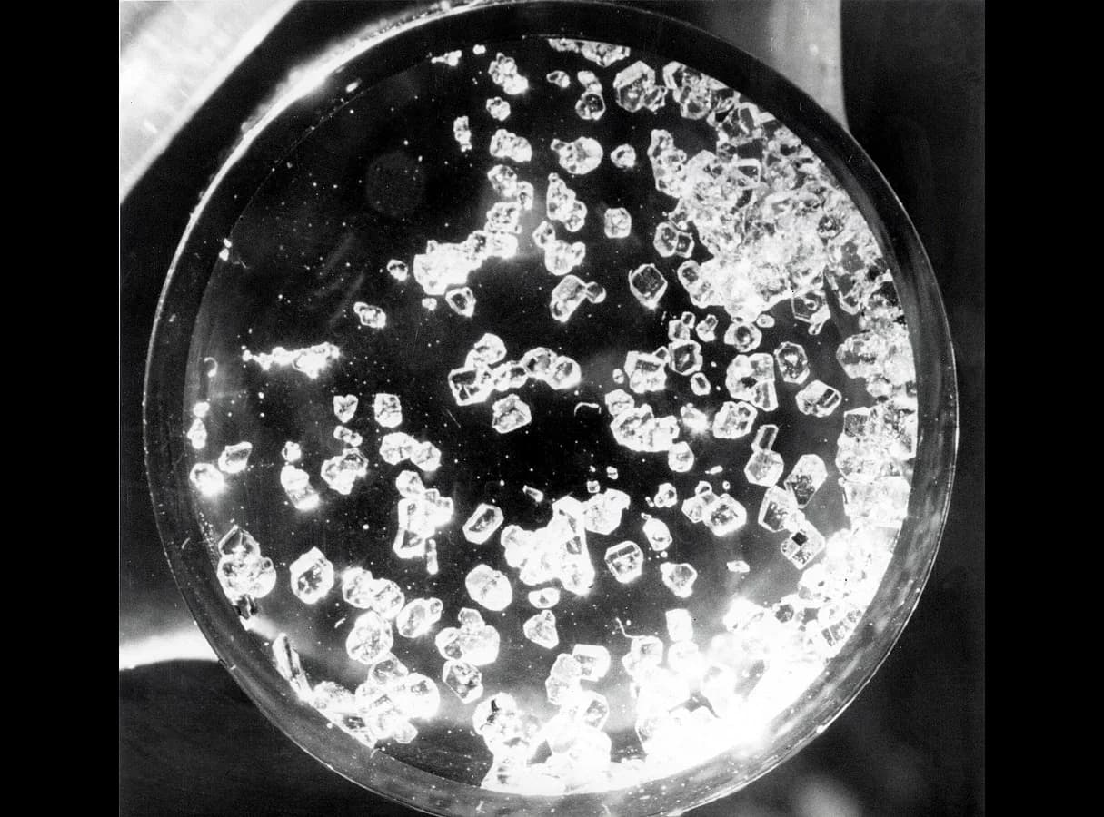 Photograph of small colourless crystals of xenon tetrafluoride, XeF4, a compound of the noble gas xenon.